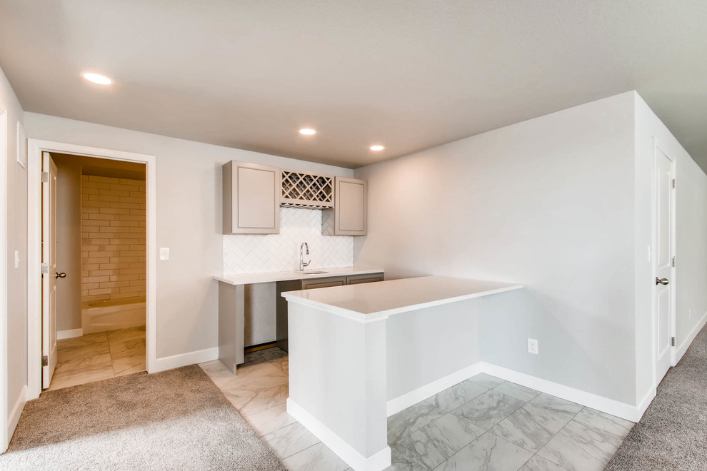 Example of a large underground carpeted and gray floor basement design in Denver with gray walls and no fireplace