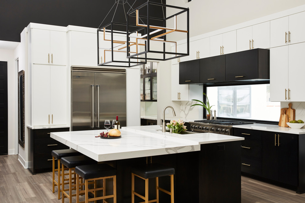 Eat-in kitchen - large contemporary l-shaped vinyl floor and brown floor eat-in kitchen idea in Minneapolis with a farmhouse sink, flat-panel cabinets, black cabinets, quartz countertops, white backsplash, quartz backsplash, stainless steel appliances, an island and white countertops