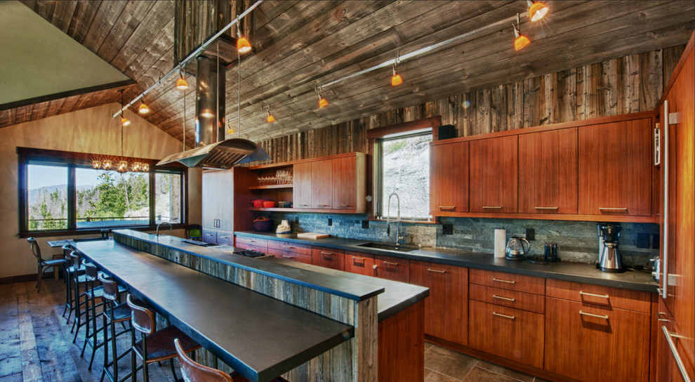 Inspiration for a mid-sized rustic single-wall medium tone wood floor open concept kitchen remodel in Denver with a drop-in sink, flat-panel cabinets, medium tone wood cabinets, granite countertops, brown backsplash, stainless steel appliances and an island