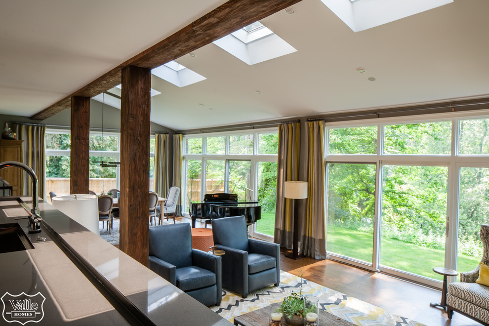 Example of a huge transitional open concept medium tone wood floor and brown floor living room design with a music area, gray walls, a corner fireplace, a stone fireplace and a wall-mounted tv
