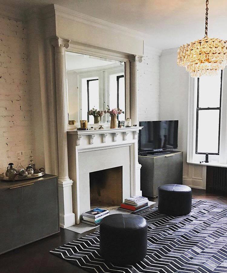 Photo of a mid-sized midcentury formal open concept living room in New York with white walls, dark hardwood floors, a standard fireplace, a brick fireplace surround, a freestanding tv and black floor.