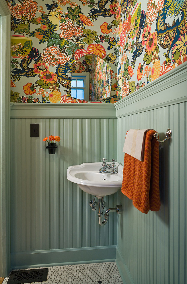 Traditional powder room in Portland with a wall-mount sink, multi-coloured walls and mosaic tile floors.