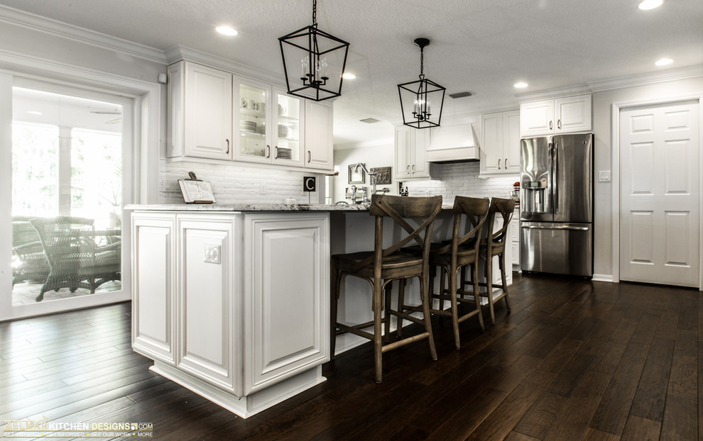Design ideas for a large traditional u-shaped eat-in kitchen in Orlando with raised-panel cabinets, white cabinets and with island.