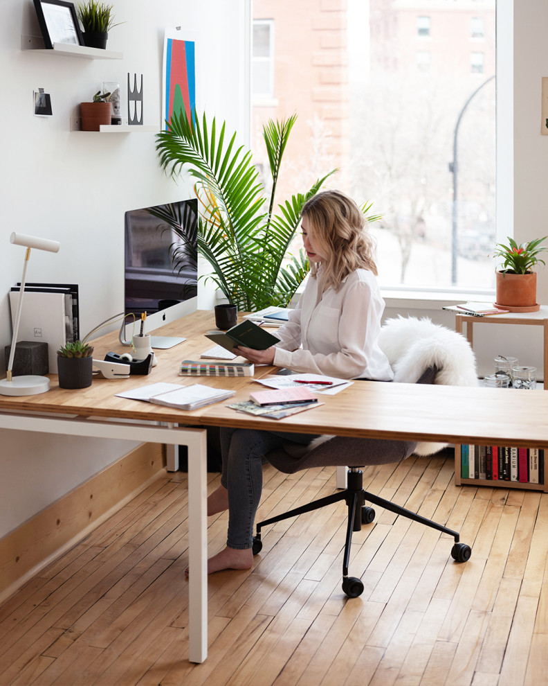 Inspiration for a mid-sized contemporary freestanding desk light wood floor and brown floor study room remodel in Chicago with white walls
