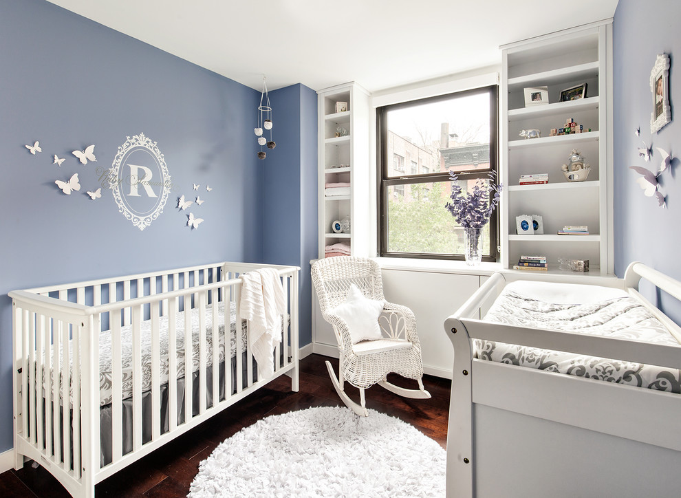Photo of a transitional nursery in New York with brown floor.