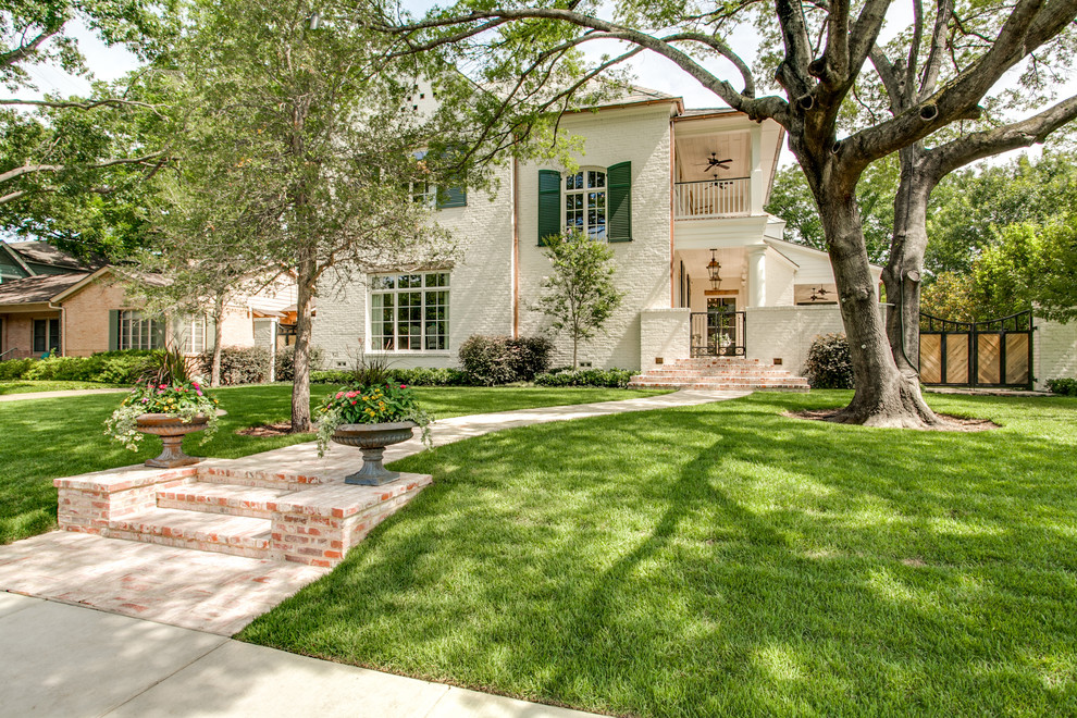 Large traditional front yard shaded garden in Dallas with with path and brick pavers.