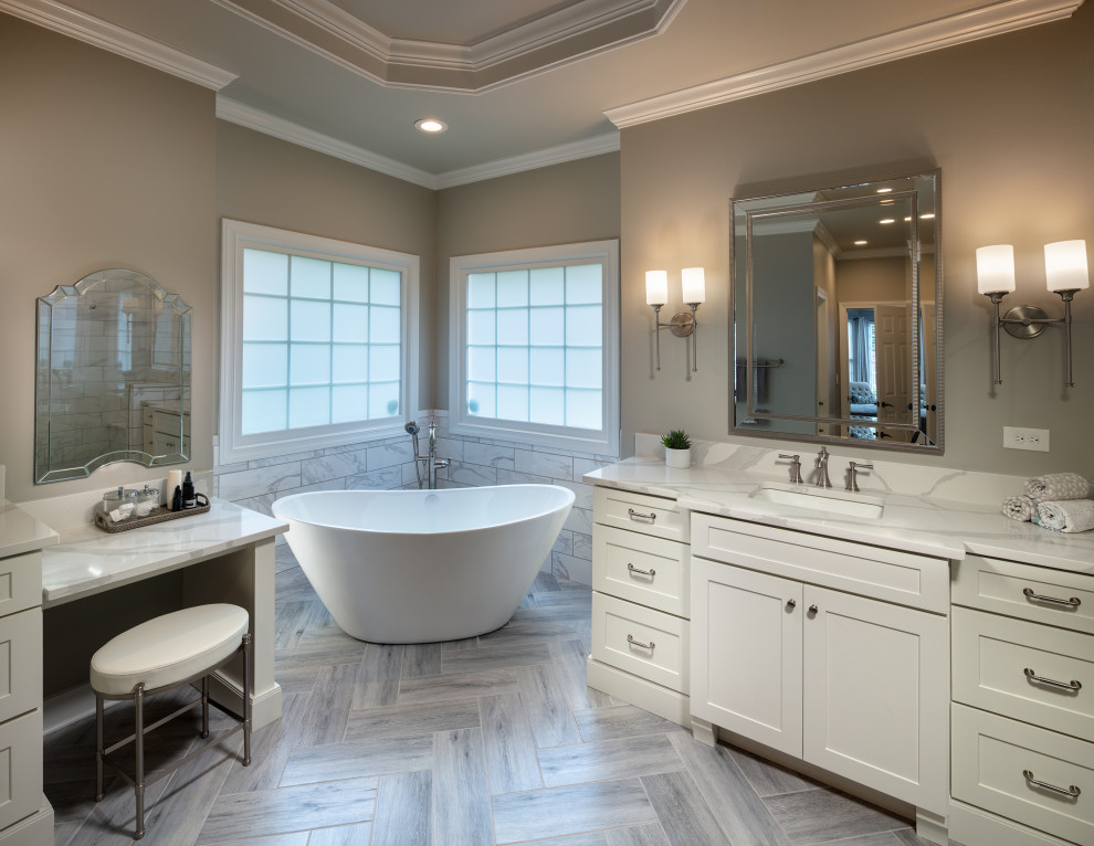 This is an example of a mid-sized modern master bathroom in Atlanta with shaker cabinets, white cabinets, a freestanding tub, a curbless shower, a one-piece toilet, gray tile, ceramic tile, grey walls, ceramic floors, an undermount sink, engineered quartz benchtops, grey floor, a hinged shower door, white benchtops, an enclosed toilet, a single vanity, a built-in vanity and coffered.