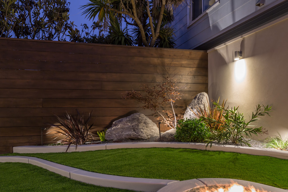 Design ideas for a small contemporary backyard full sun xeriscape in San Francisco with a fire feature and concrete pavers.