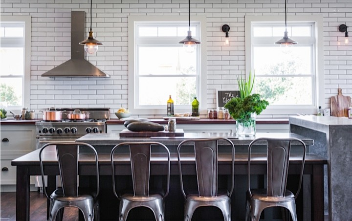 Example of a large mountain style u-shaped medium tone wood floor eat-in kitchen design with an integrated sink, shaker cabinets, green cabinets, concrete countertops, white backsplash, subway tile backsplash, stainless steel appliances and an island