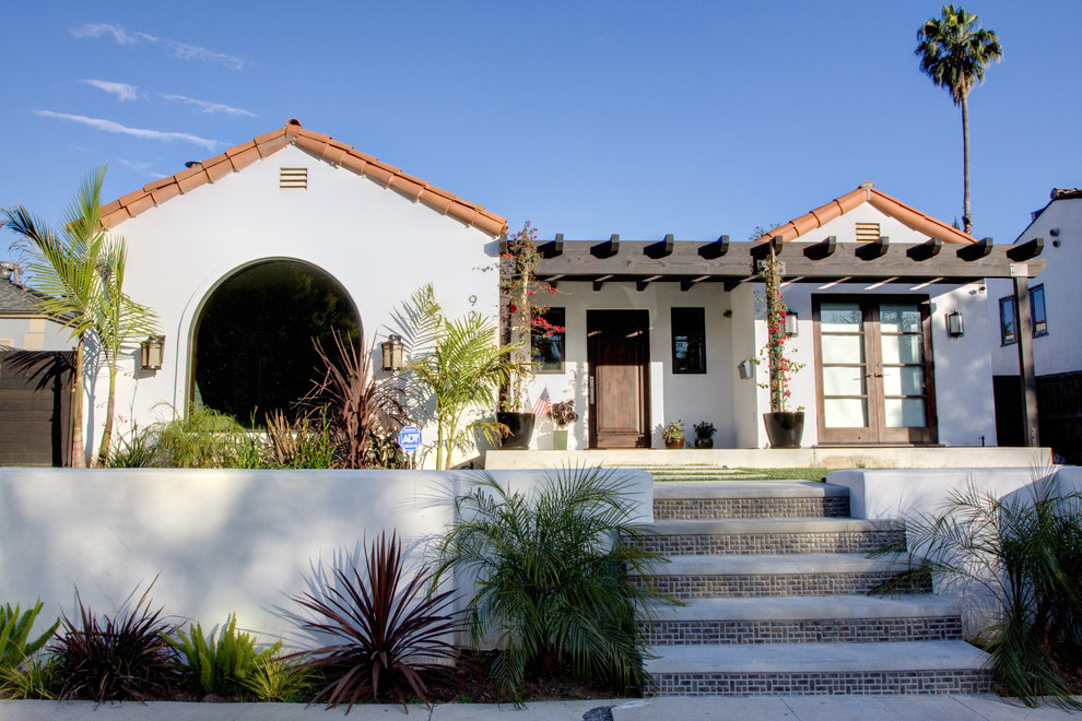 Large mediterranean one-storey stucco white exterior in Los Angeles.