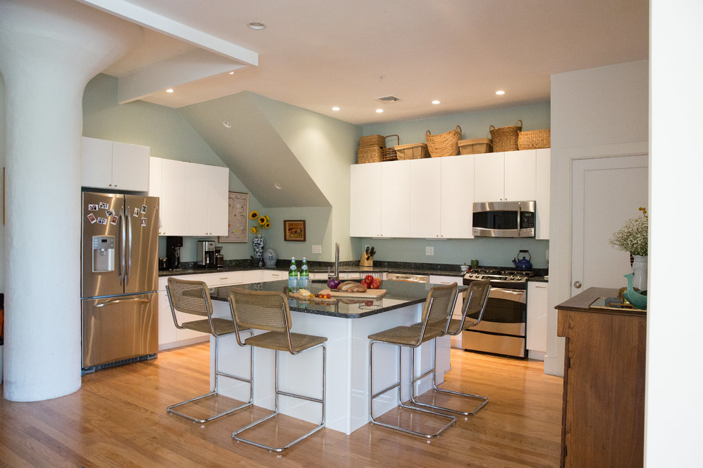 Open concept kitchen - mid-sized contemporary l-shaped light wood floor open concept kitchen idea in Chicago with a double-bowl sink, flat-panel cabinets, white cabinets, quartz countertops, stainless steel appliances and an island