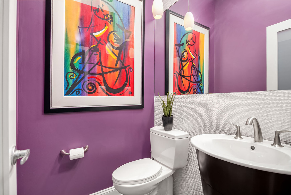 Photo of a small contemporary powder room in Chicago with white tile, purple walls, a two-piece toilet, porcelain tile, a console sink, flat-panel cabinets and dark wood cabinets.