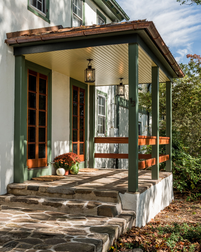 Inspiration for a country verandah in Philadelphia with natural stone pavers and a roof extension.