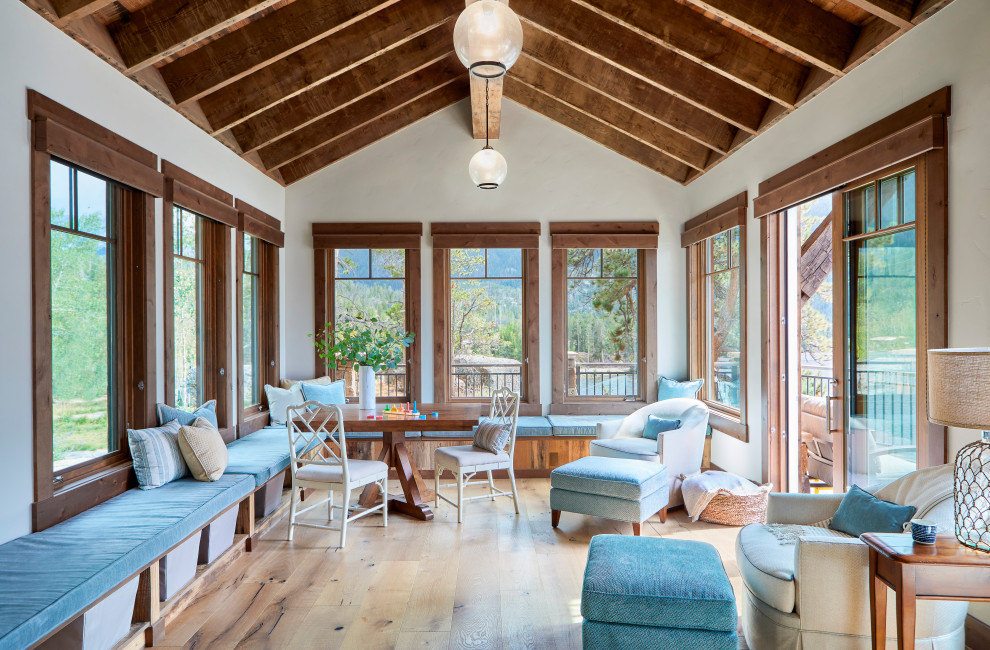 Inspiration for a large country sunroom in Denver with light hardwood floors and brown floor.