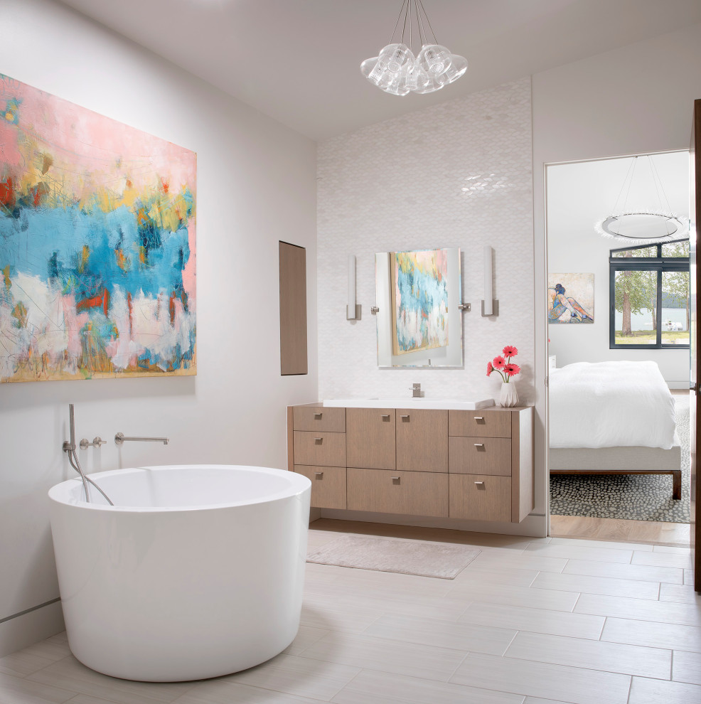 Photo of a mid-sized contemporary master bathroom in Other with flat-panel cabinets, medium wood cabinets, a freestanding tub, white tile, ceramic tile, white walls, ceramic floors, a drop-in sink, wood benchtops, beige floor and brown benchtops.