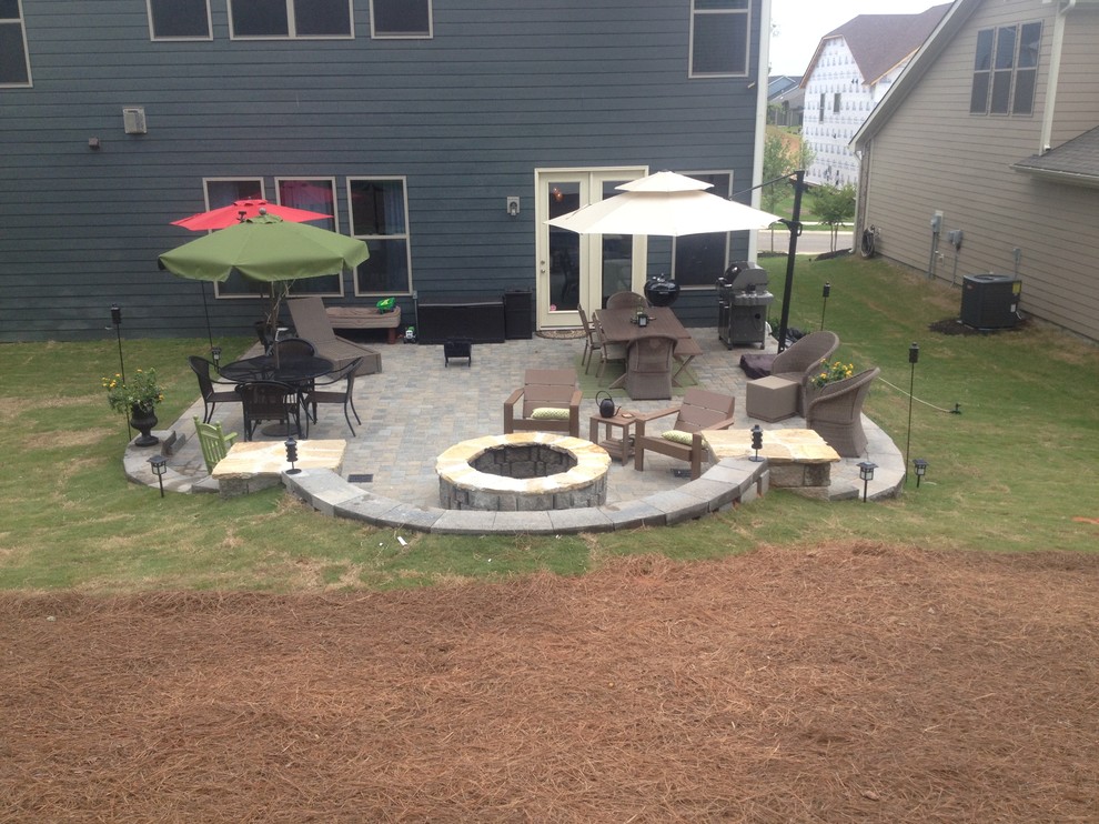 Photo of a mid-sized traditional backyard patio in Charlotte with a fire feature, concrete pavers and no cover.