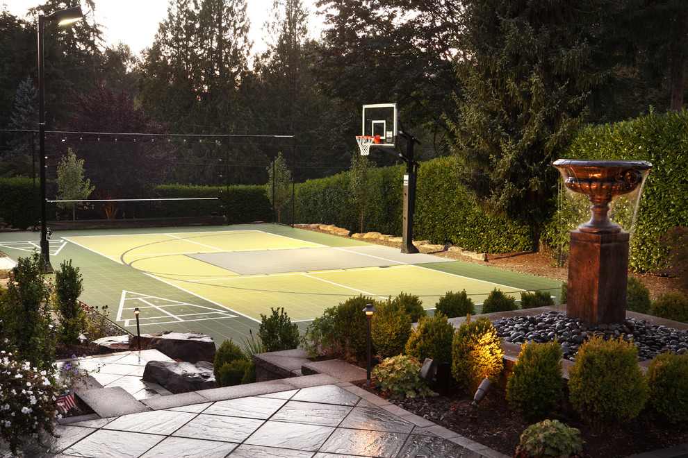 Photo of a large traditional backyard full sun outdoor sport court in Seattle with a water feature and concrete pavers.