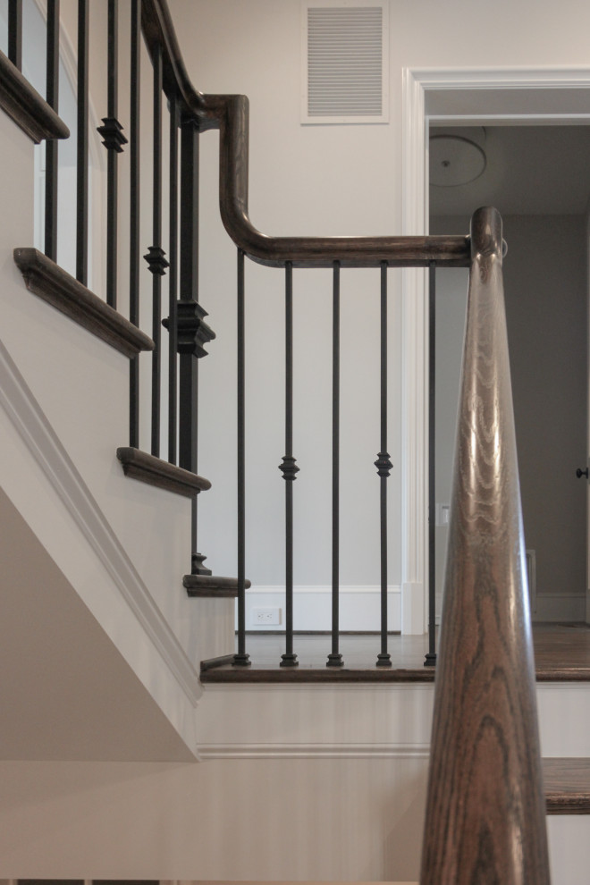 Foto de escalera suspendida tradicional grande con escalones de madera, contrahuellas de madera pintada y barandilla de metal