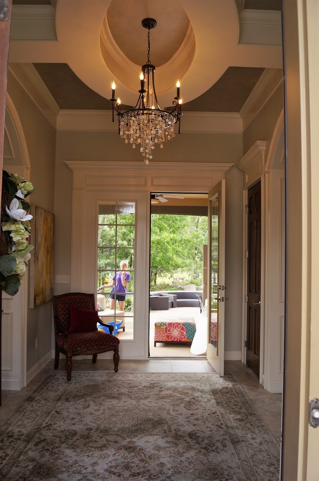 Inspiration for a large transitional porcelain tile and beige floor foyer remodel in Columbus with beige walls