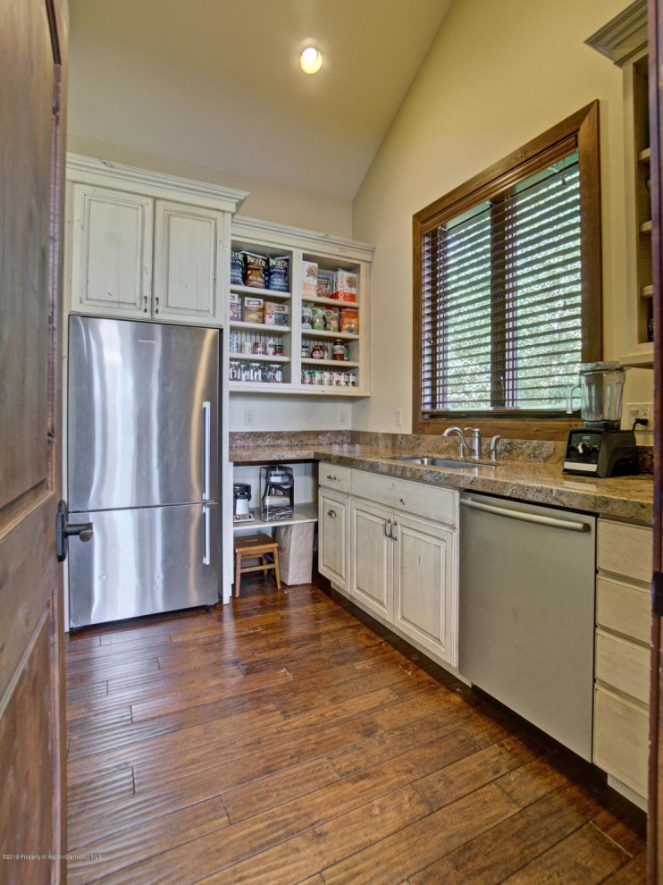 This is an example of a large transitional l-shaped kitchen pantry in Denver with recessed-panel cabinets, light wood cabinets, granite benchtops, stainless steel appliances and medium hardwood floors.