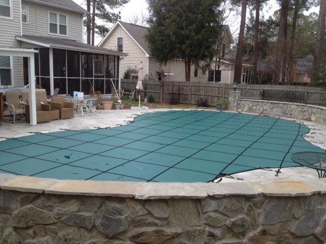 Backyard stamped concrete and rectangular pool photo