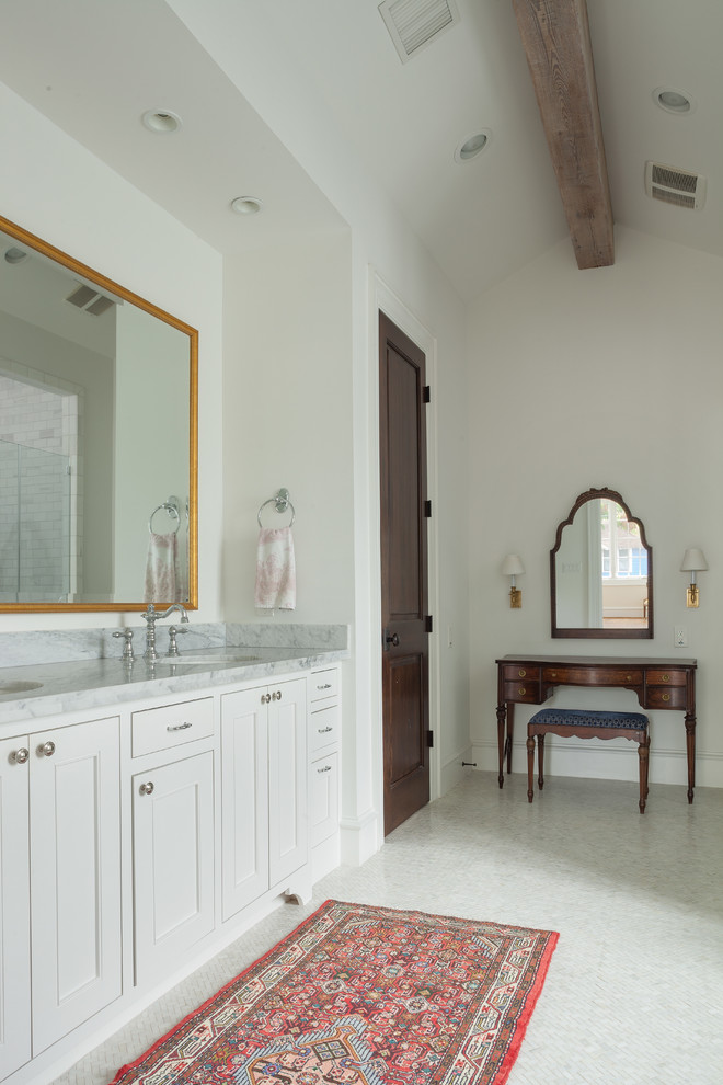 Photo of an expansive traditional master bathroom in Houston with an undermount sink, shaker cabinets, white cabinets, marble benchtops, white walls, mosaic tile floors, a freestanding tub, white floor, grey benchtops, a double vanity, a built-in vanity and exposed beam.