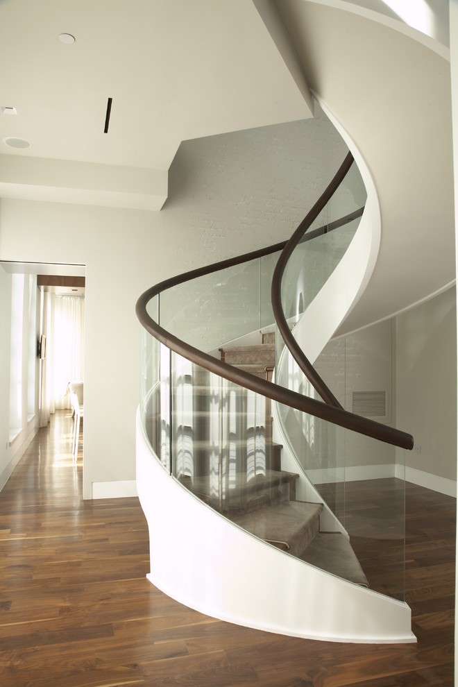 Design ideas for a mid-sized contemporary wood curved staircase in New York with wood risers.