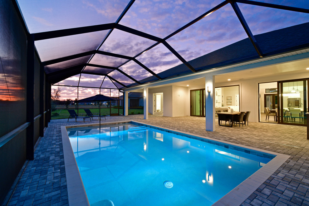 Pool fountain - mid-sized transitional backyard concrete paver and rectangular lap pool fountain idea