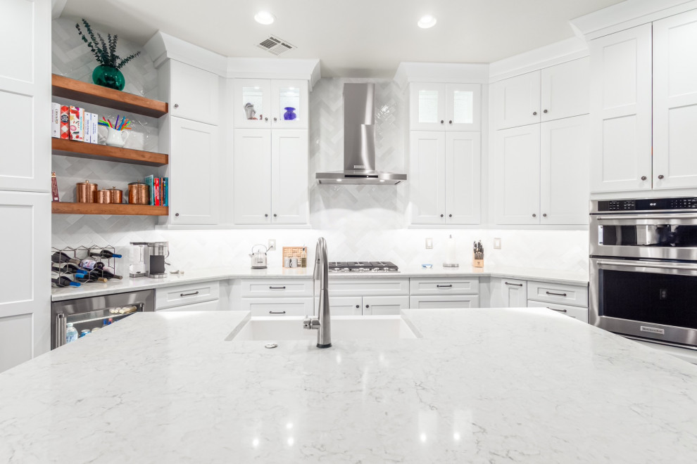 Example of a transitional kitchen design in Phoenix with a farmhouse sink, shaker cabinets, white cabinets, white backsplash, subway tile backsplash and white countertops