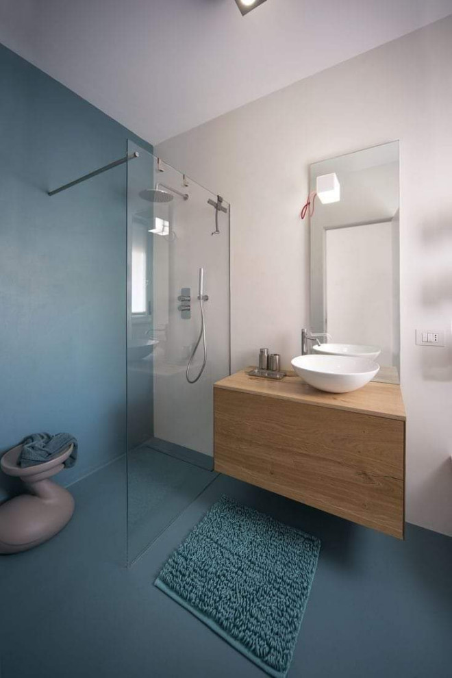 Design ideas for a small modern 3/4 bathroom in Other with flat-panel cabinets, light wood cabinets, a curbless shower, a two-piece toilet, cement tile, white walls, concrete floors, a vessel sink, wood benchtops, turquoise floor, an open shower, beige benchtops, a single vanity and a floating vanity.
