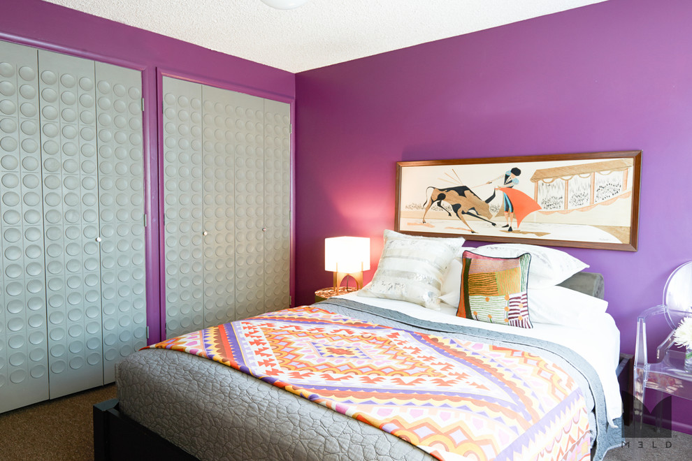 This is an example of a mid-sized eclectic master bedroom in Salt Lake City with purple walls, carpet and no fireplace.