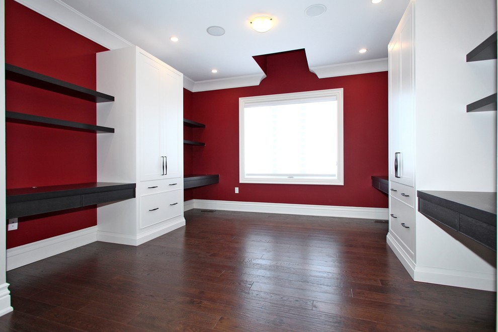 Design ideas for a large transitional study room in Toronto with red walls, dark hardwood floors, no fireplace and a built-in desk.