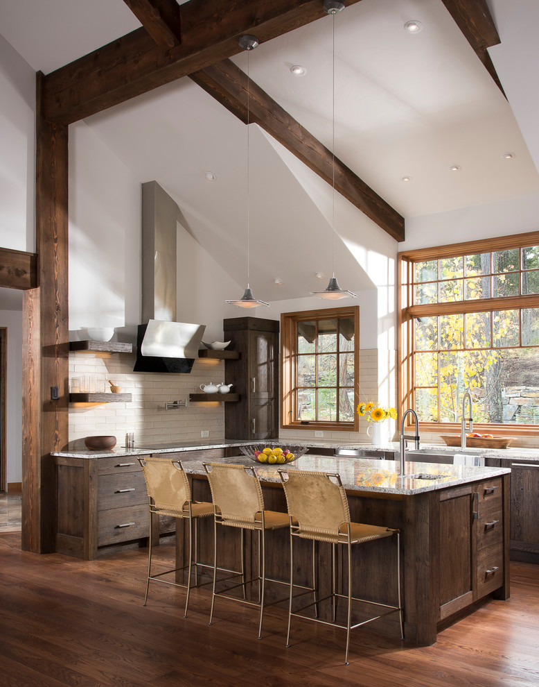 Inspiration for a rustic u-shaped medium tone wood floor and brown floor kitchen remodel with an undermount sink, shaker cabinets, dark wood cabinets, beige backsplash, subway tile backsplash and an island