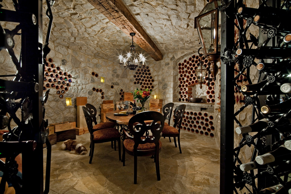 Large traditional wine cellar in Detroit with storage racks and limestone floors.