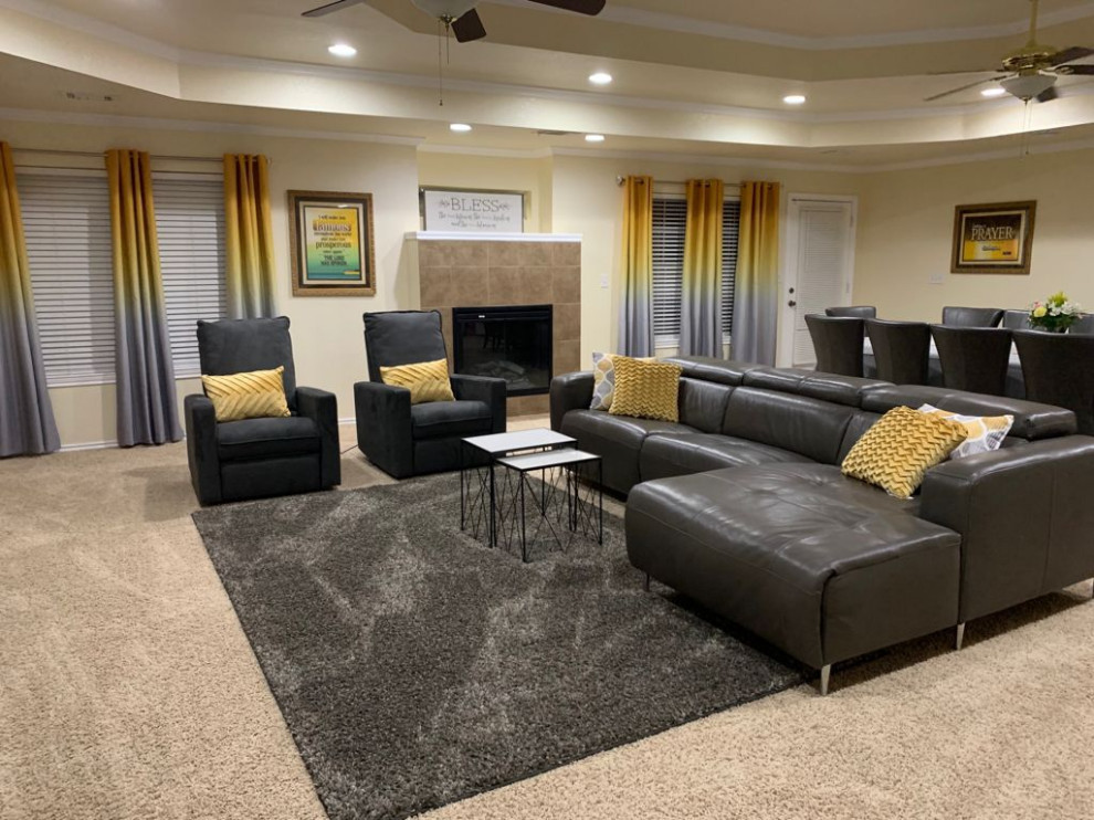 This is an example of a large contemporary open concept living room with yellow walls, grey floor, carpet, a standard fireplace and a tile fireplace surround.