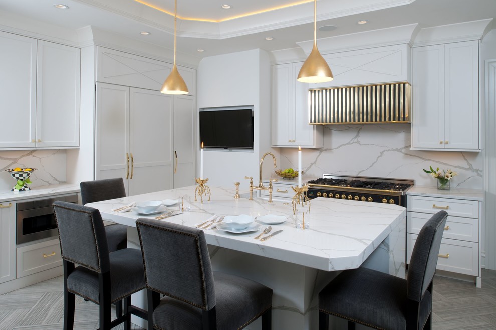 Example of a transitional l-shaped brown floor kitchen design with a farmhouse sink, shaker cabinets, white cabinets, white backsplash, an island and white countertops