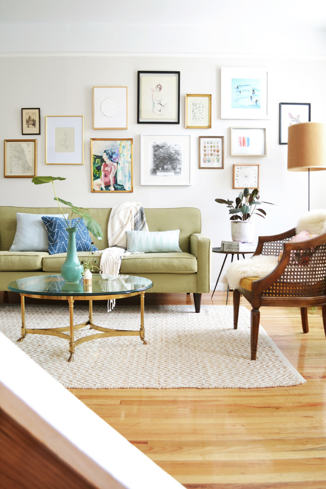 Design ideas for an eclectic living room in New York with white walls and light hardwood floors.