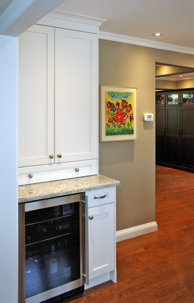 Large transitional single-wall medium tone wood floor eat-in kitchen photo in Toronto with shaker cabinets, white cabinets, quartz countertops and stainless steel appliances
