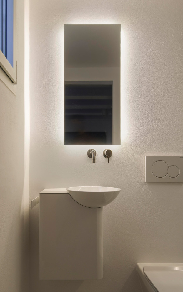 Photo of a mediterranean 3/4 bathroom in Other with a curbless shower, gray tile, white walls, an open shower and white benchtops.