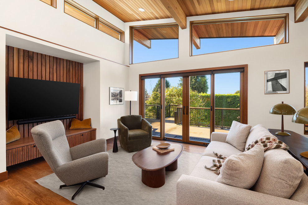 Example of a large 1960s formal and open concept medium tone wood floor, brown floor and wood ceiling living room design in Seattle with white walls and a wall-mounted tv