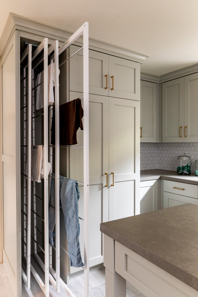 Design ideas for a large u-shaped dedicated laundry room in Salt Lake City with an undermount sink, shaker cabinets, green cabinets, quartzite benchtops, mosaic tile splashback, marble floors, an integrated washer and dryer, grey floor and grey benchtop.