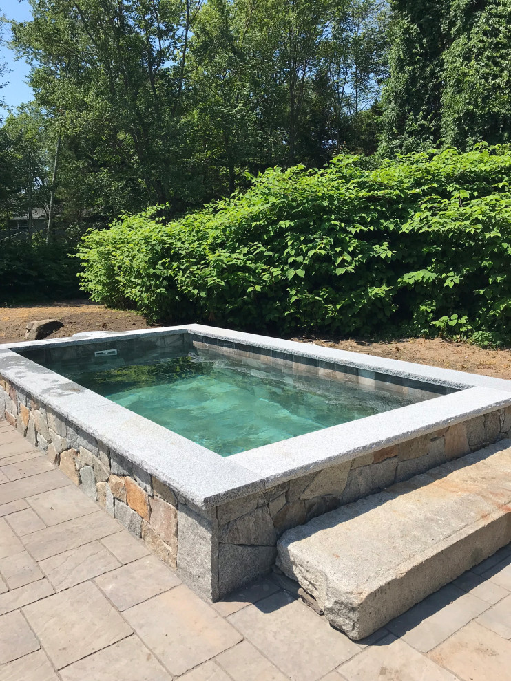 Small country backyard rectangular infinity pool in Portland Maine with a hot tub and concrete pavers.