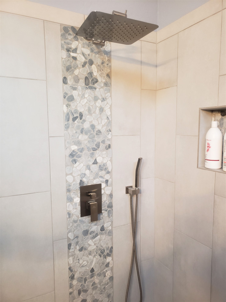 This is an example of a master bathroom in Phoenix with an open shower, ceramic tile, pebble tile floors, an open shower and a shower seat.