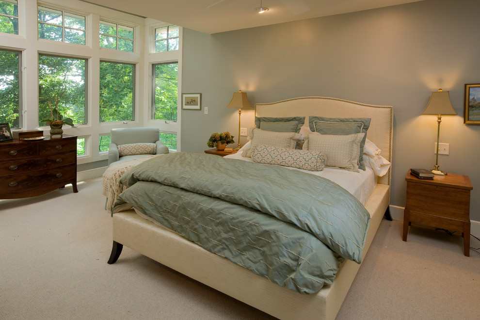 Photo of a mid-sized traditional master bedroom in Other with blue walls and carpet.