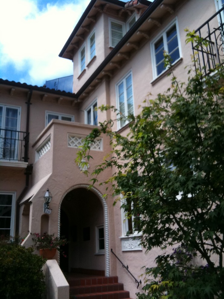 Photo of a large traditional two-storey stucco beige exterior in San Francisco with a hip roof.