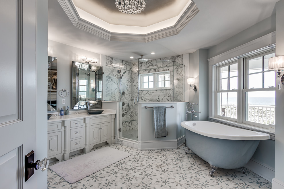 This is an example of a large beach style bathroom in Philadelphia with marble floors.