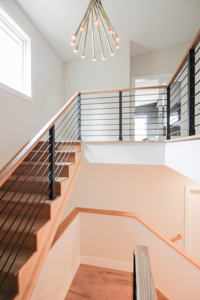 Large modern wood straight staircase in DC Metro with wood risers and mixed railing.