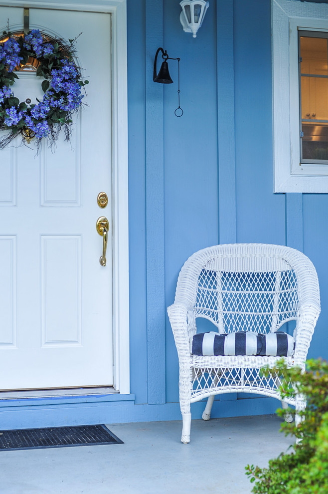 This is an example of a traditional front door in Sacramento with blue walls, a single front door and a white front door.