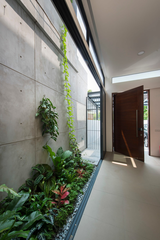 Contemporary entryway in Singapore with a single front door and a dark wood front door.
