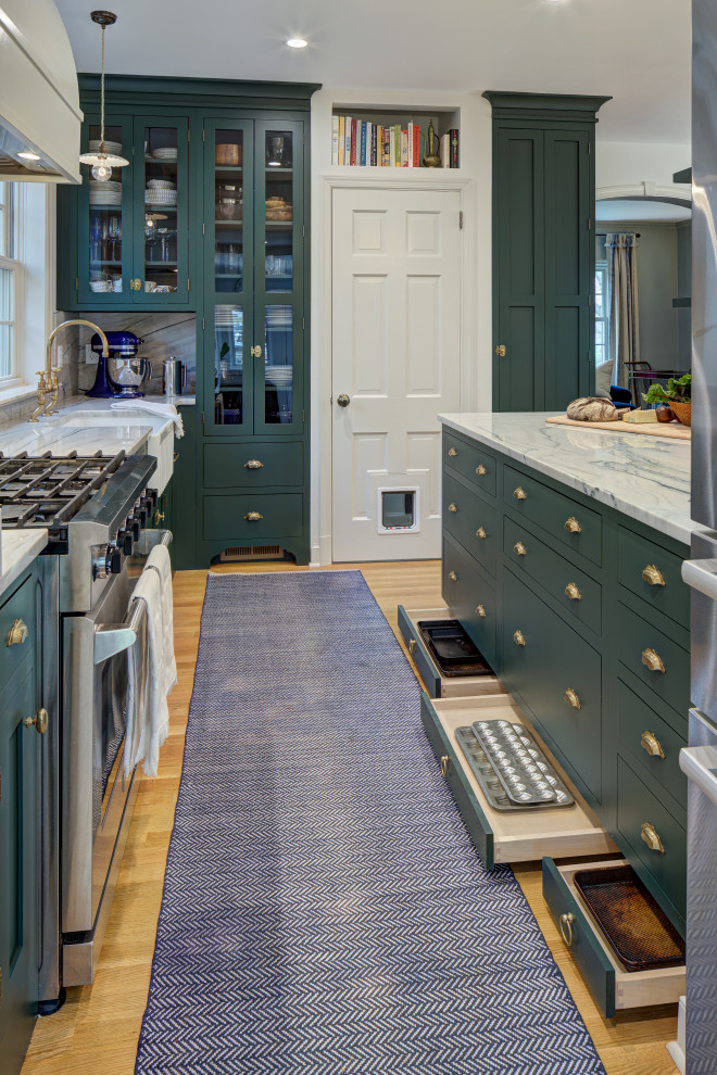 Inspiration for a small timeless l-shaped light wood floor and brown floor eat-in kitchen remodel in DC Metro with green cabinets, white backsplash, stainless steel appliances, a peninsula, white countertops, quartzite countertops, a farmhouse sink and shaker cabinets